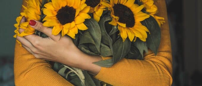 happy woman holding sunflowers